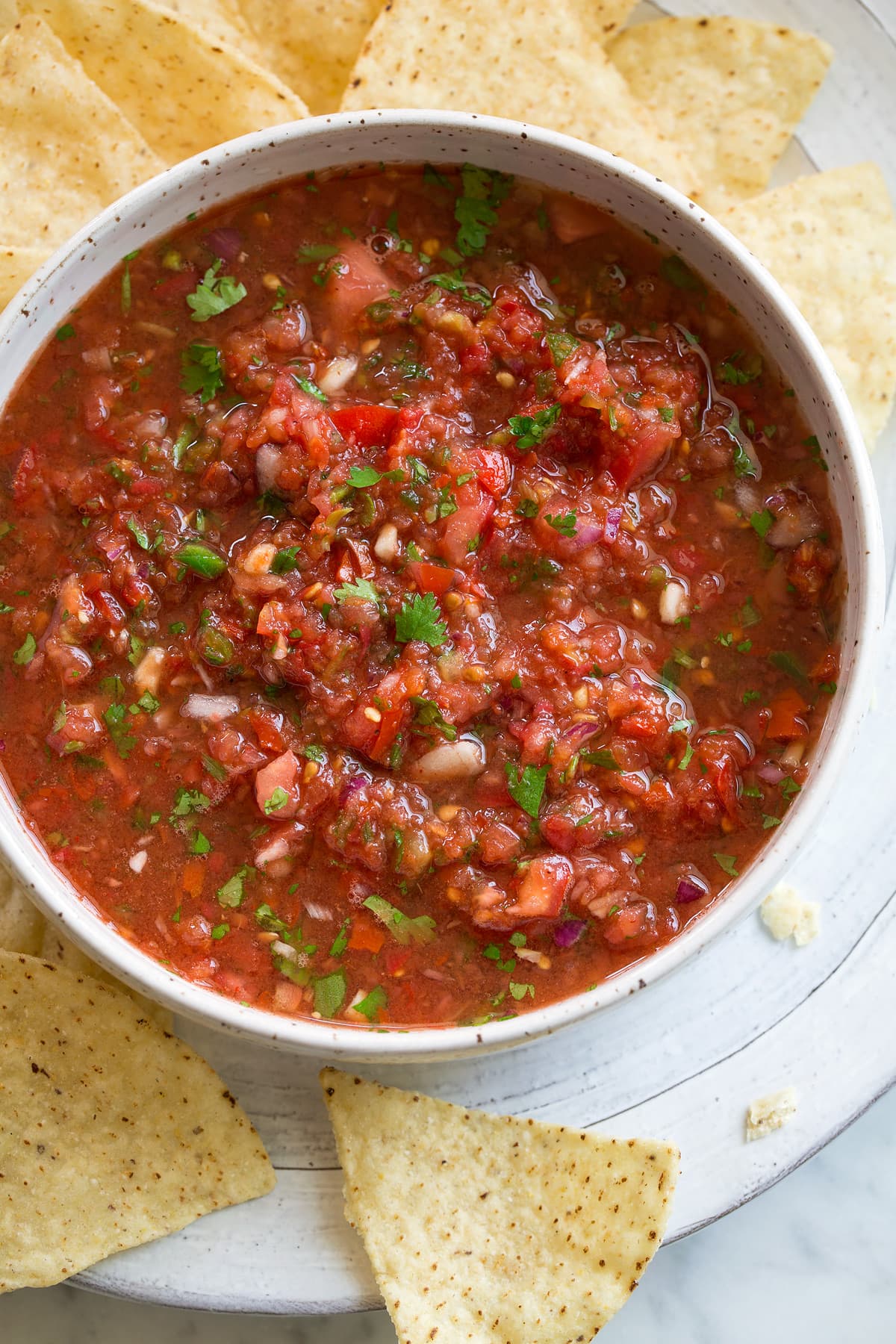 Fresh homemade salsa! Fresh Homemade Salsa in a white bowl with tortilla chips on the side.