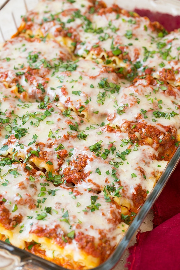 Lasagna Roll Ups. Not only look incredible but taste incredible. There's served in individual portions and are great for freezing too. | Lasagna Recipes | Easy Lasagna | #cookingclassy #lasagna #pasta #rollups A close up of a Lasagna Roll Ups in a baking dish