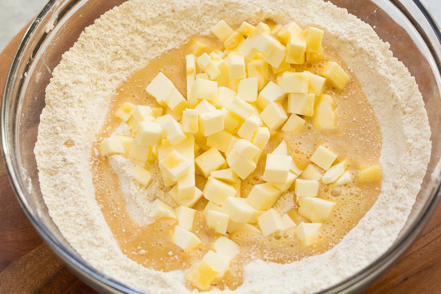 Apple Pie Bars Butter, whisked egg, vanilla and flour sugar mixture in a glass mixing bowl.