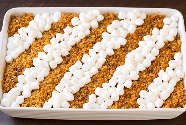 Note that if you are making this in advance to refrigerate then bake the following day, don't add the corn flake topping until baking or it will become stale. Also I'd recommend placing cold casserole in cool oven and let it preheat with oven. Adding mini marshmallows to sweet potato casserole in rows.