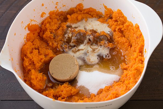 Note that if you are making this in advance to refrigerate then bake the following day, don't add the corn flake topping until baking or it will become stale. Also I'd recommend placing cold casserole in cool oven and let it preheat with oven. Adding sugars, salt and melted browned butter to sweet potatoes in mixing bowl.