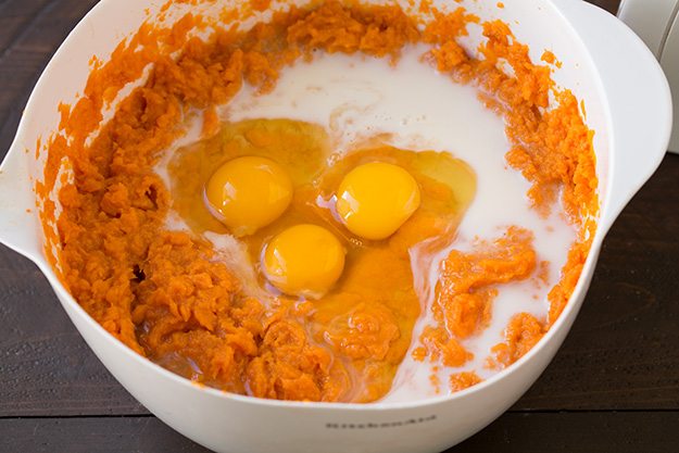 Note that if you are making this in advance to refrigerate then bake the following day, don't add the corn flake topping until baking or it will become stale. Also I'd recommend placing cold casserole in cool oven and let it preheat with oven. Adding eggs and milk to sweet potatoes in mixing bowl.
