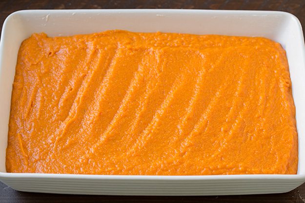 Note that if you are making this in advance to refrigerate then bake the following day, don't add the corn flake topping until baking or it will become stale. Also I'd recommend placing cold casserole in cool oven and let it preheat with oven. Spreading sweet potatoes into an even layer in baking dish.