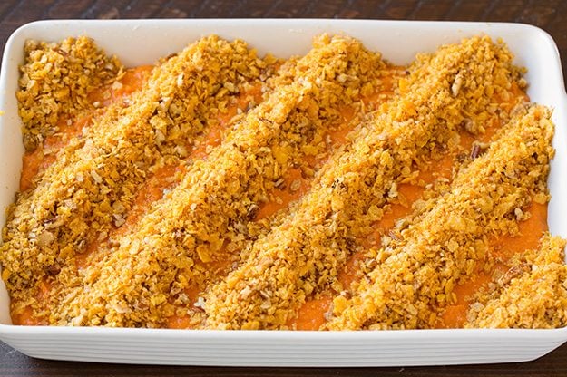 Note that if you are making this in advance to refrigerate then bake the following day, don't add the corn flake topping until baking or it will become stale. Also I'd recommend placing cold casserole in cool oven and let it preheat with oven. Spreading topping into rows over sweet potatoes layer.