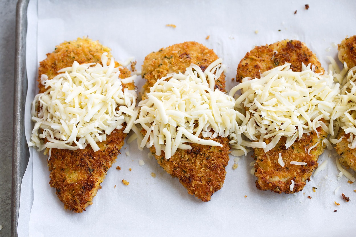 topping lemon chicken romano with cheese mixture before baking