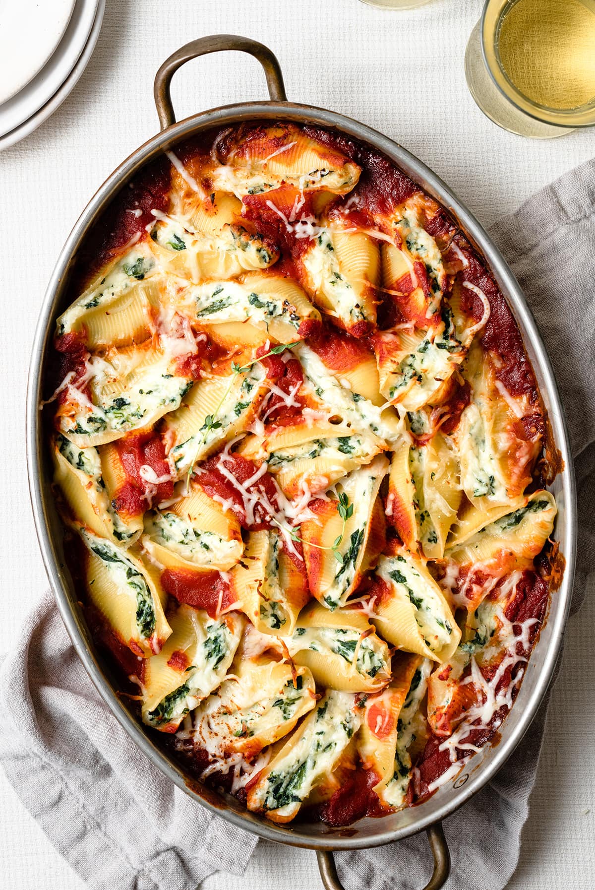 Spinach and Cheese Stuffed Shells Stuffed Shells in a large oval baking dish. They're filled with cheese and spinach and covered with marinara sauce.