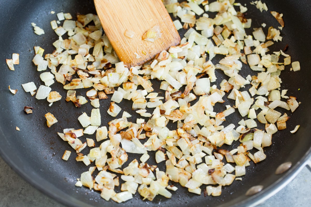 Sweet Potato and Black Bean Tacos Sautéing onion in skillet to make sweet potato tacos.