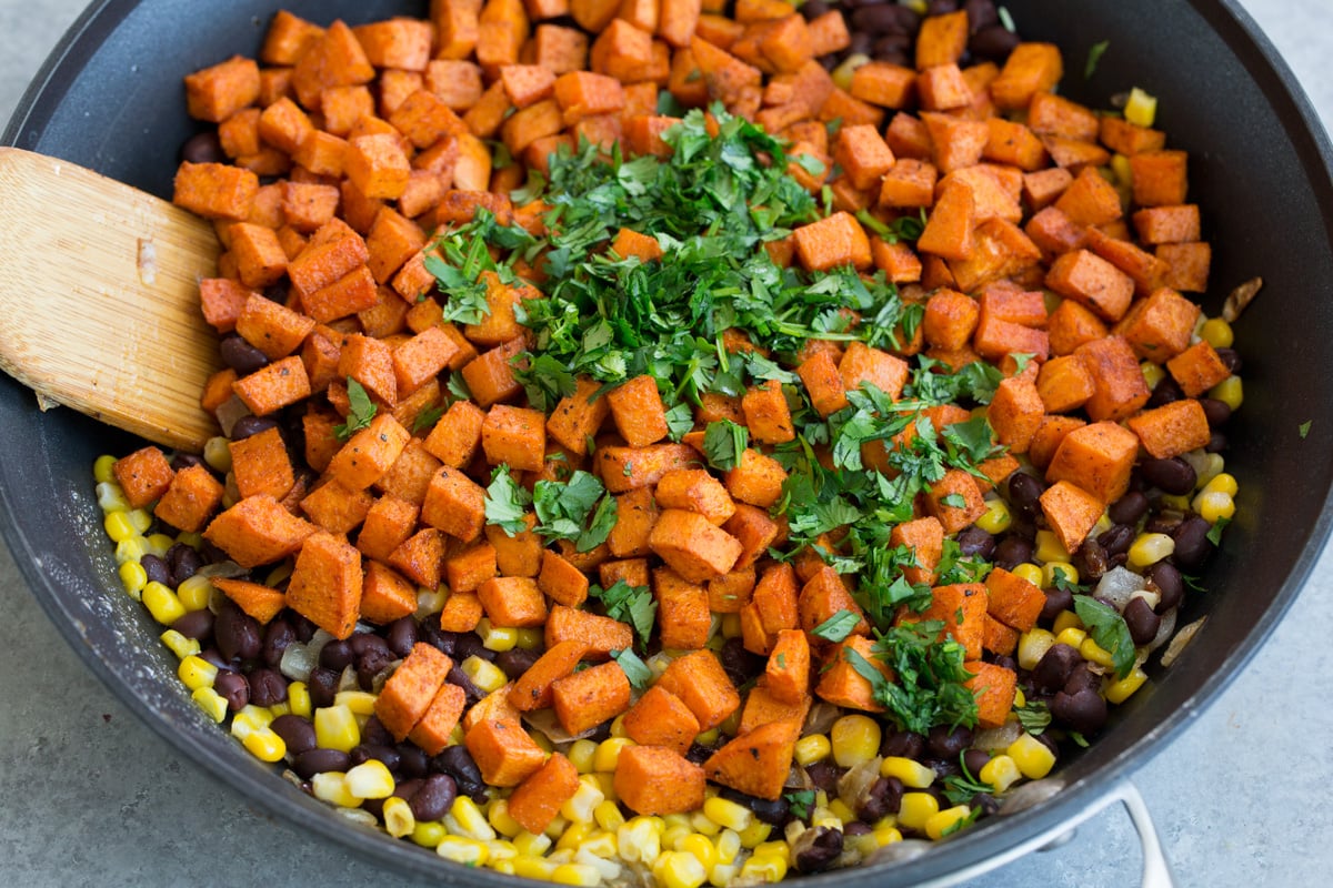 Sweet Potato and Black Bean Tacos Adding sweet potatoes cilantro to skillet