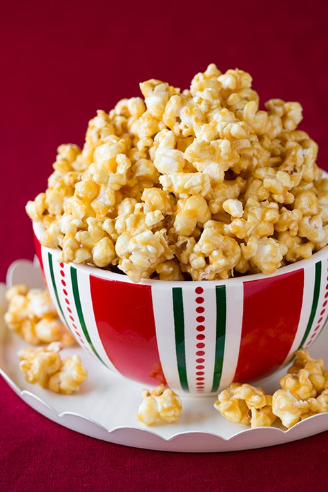 Caramel Popcorn Mound of caramel popcorn in a serving bowl over a white platter.