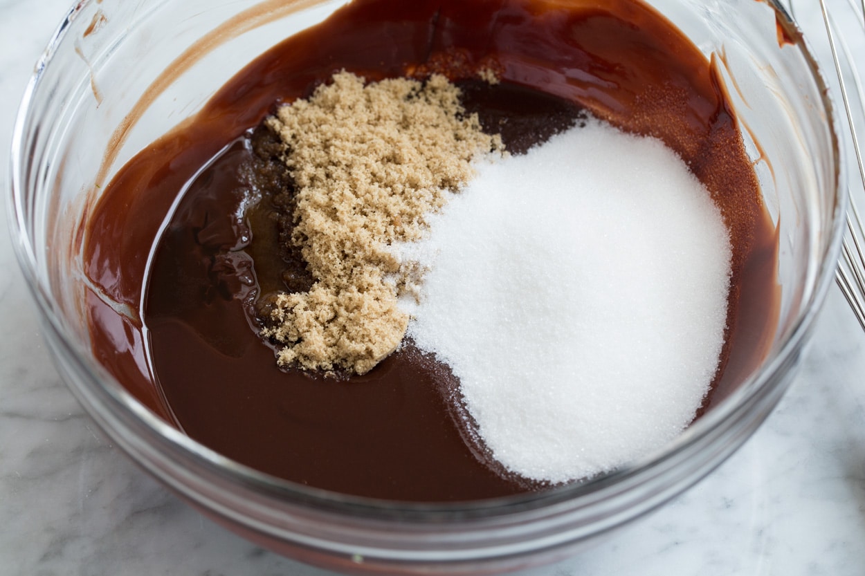 The BEST Flourless Chocolate Cake! Mixing sugars into melted chocolate mixture in mixing bowl.