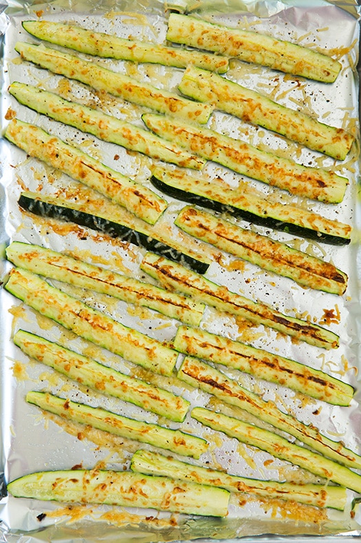 Oven roasted zucchini with parmesan, garlic and lemon. Baked zucchini is the best way to cook vegetables. Fresh parmesan zucchini baked in the oven is so refreshing. #cookingclassy #zucchini #fries #vegetables #sides Oven Roasted Zucchini With Parmesan and Garlic Seasoning on a baking sheet