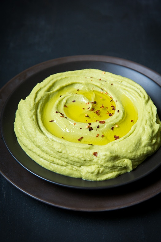 Avocado Hummus in a small black bowl