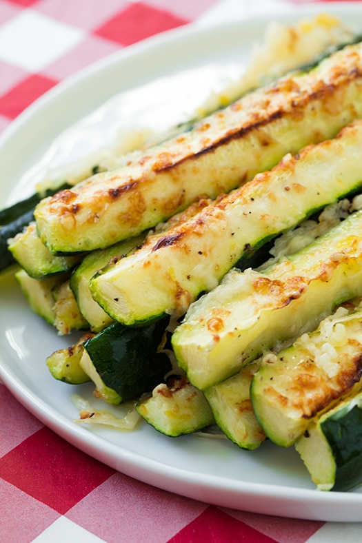 Oven roasted zucchini with parmesan, garlic and lemon. Baked zucchini is the best way to cook vegetables. Fresh parmesan zucchini baked in the oven is so refreshing. #cookingclassy #zucchini #fries #vegetables #sides Baked Zucchini Sticks with Parmesna on Plate
