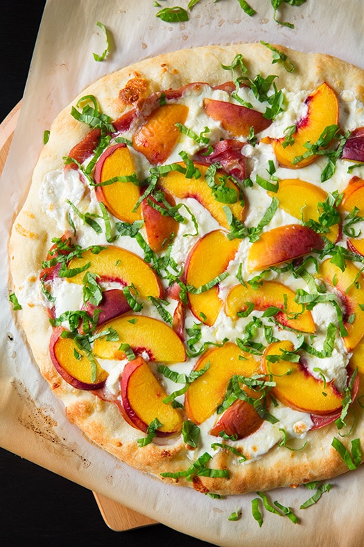 Peach and Prosciutto Pizza garnished with fresh basil