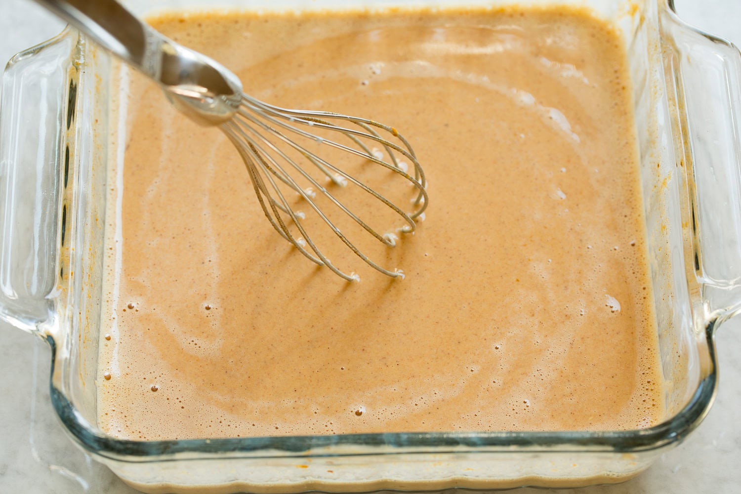 Pumpkin French Toast Finished custard mixture for pumpkin french toast in glass dish.