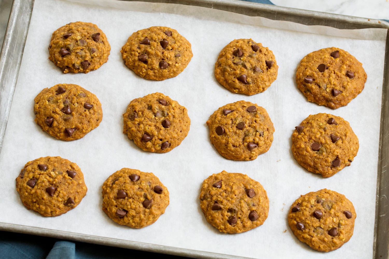 Pumpkin Oatmeal Chocolate Chip Cookies Baked pumpkin oat cookies on cookie sheet.