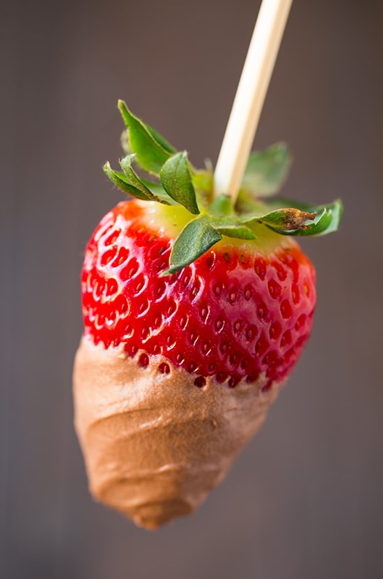 Chocolate Fruit Dip | Cooking Classy Close up image of chocolate fruit dip covering a fresh strawberry on a skewer