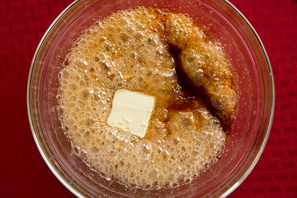 Peanut Brittle Adding butter and vanilla mixture in mixing bowl.