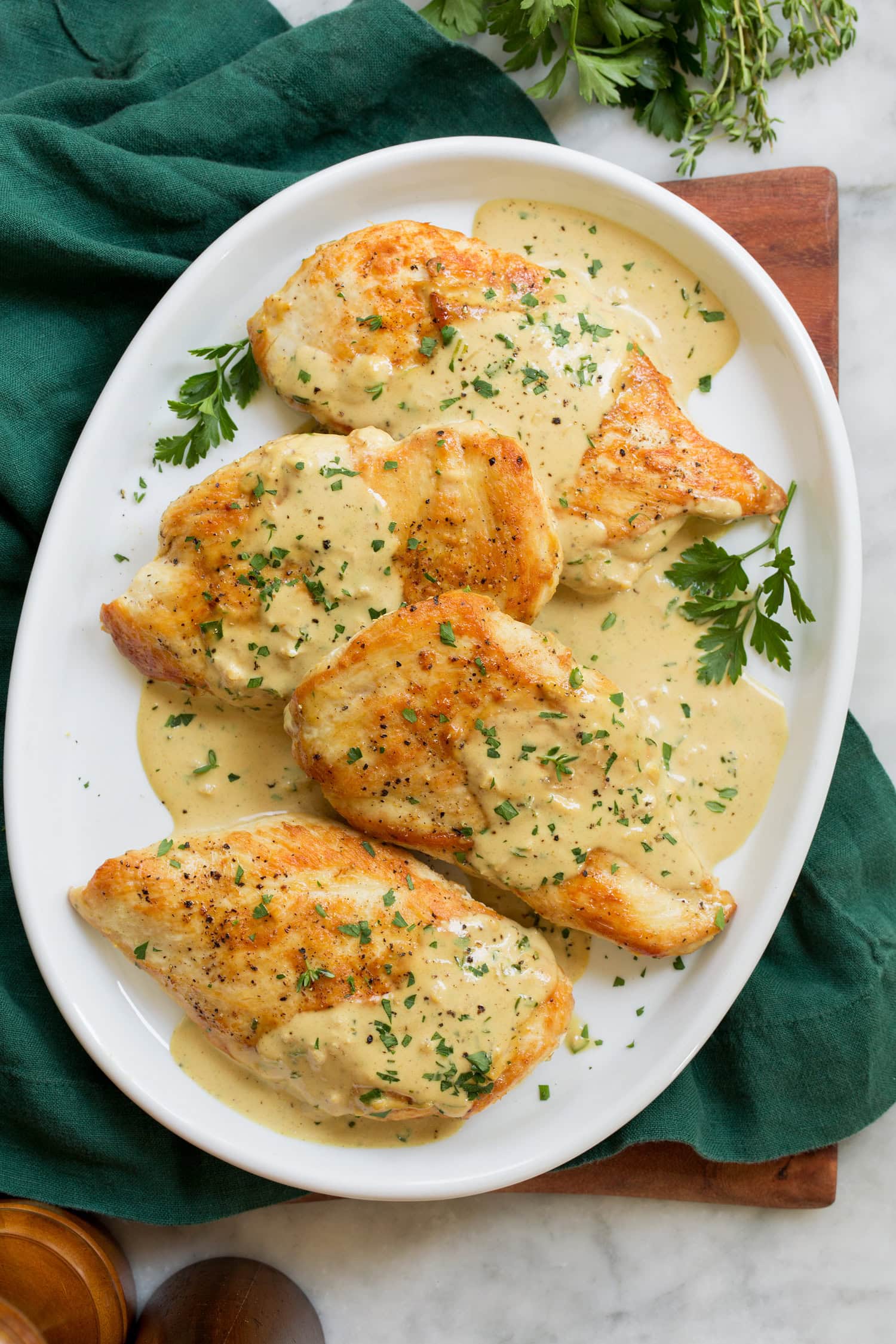 Creamy Dijon Mustard Chicken Overhead photo of four pieces of chicken with mustard sauce.