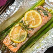 A close up of salmon and asparagus in foil