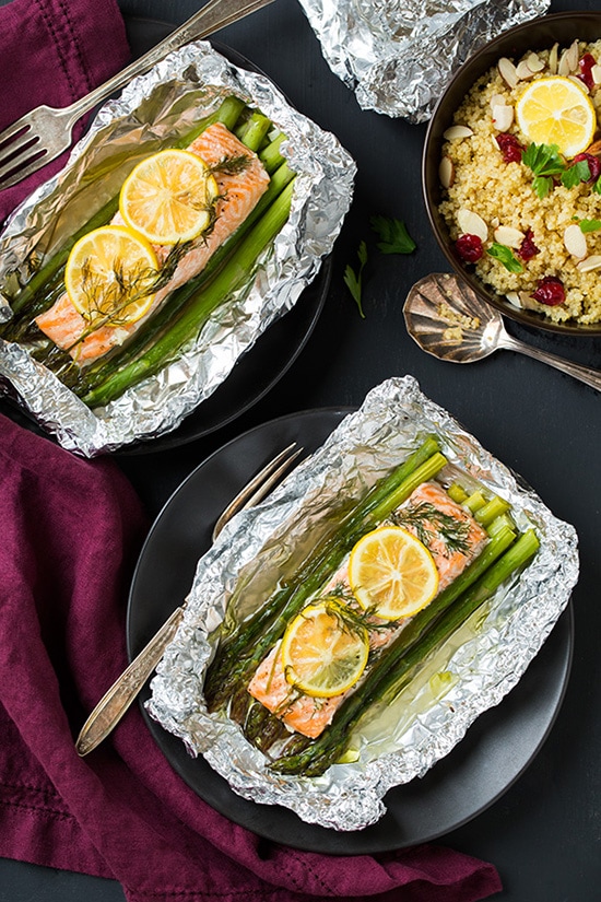 Baked Salmon and Asparagus in Foil Two plates of Salmon and Asparagus in Foil topped with lemon wedges
