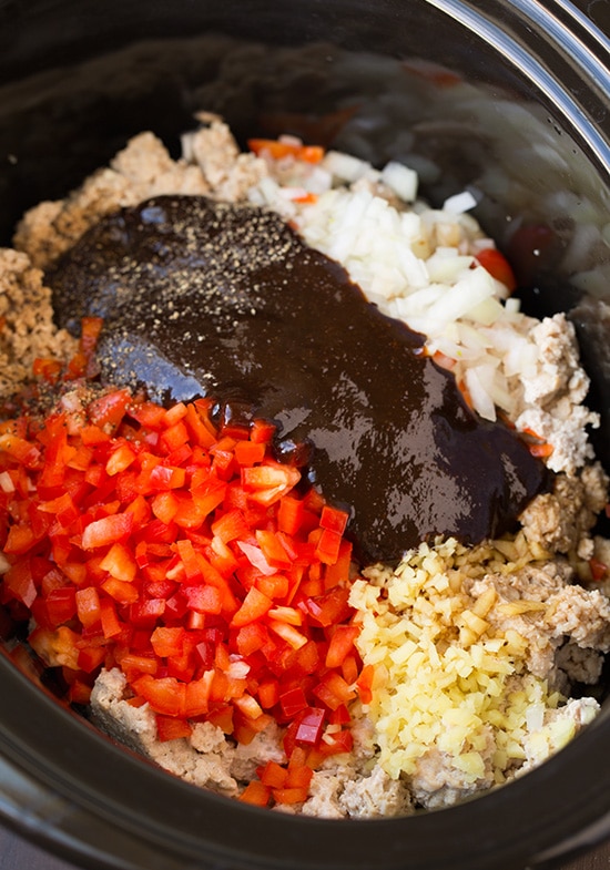 Slow Cooker Asian Chicken Lettuce Wraps. So simple to put together and make such a delicious and healthy weeknight dinner. These wraps are so easy to adapt and can be topped with your favorite sauces, dips and veggies. #cookingclassy #wraps #Asianfood #chicken Ingredients in a slow cooker for making Asian Chicken Lettuce Wraps