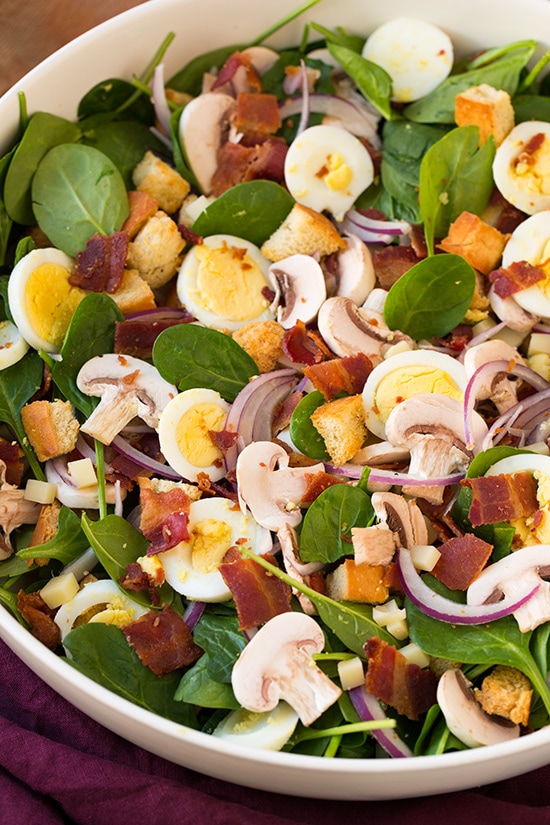 Spinach Salad with Warm Bacon Dressing in a large white bowl