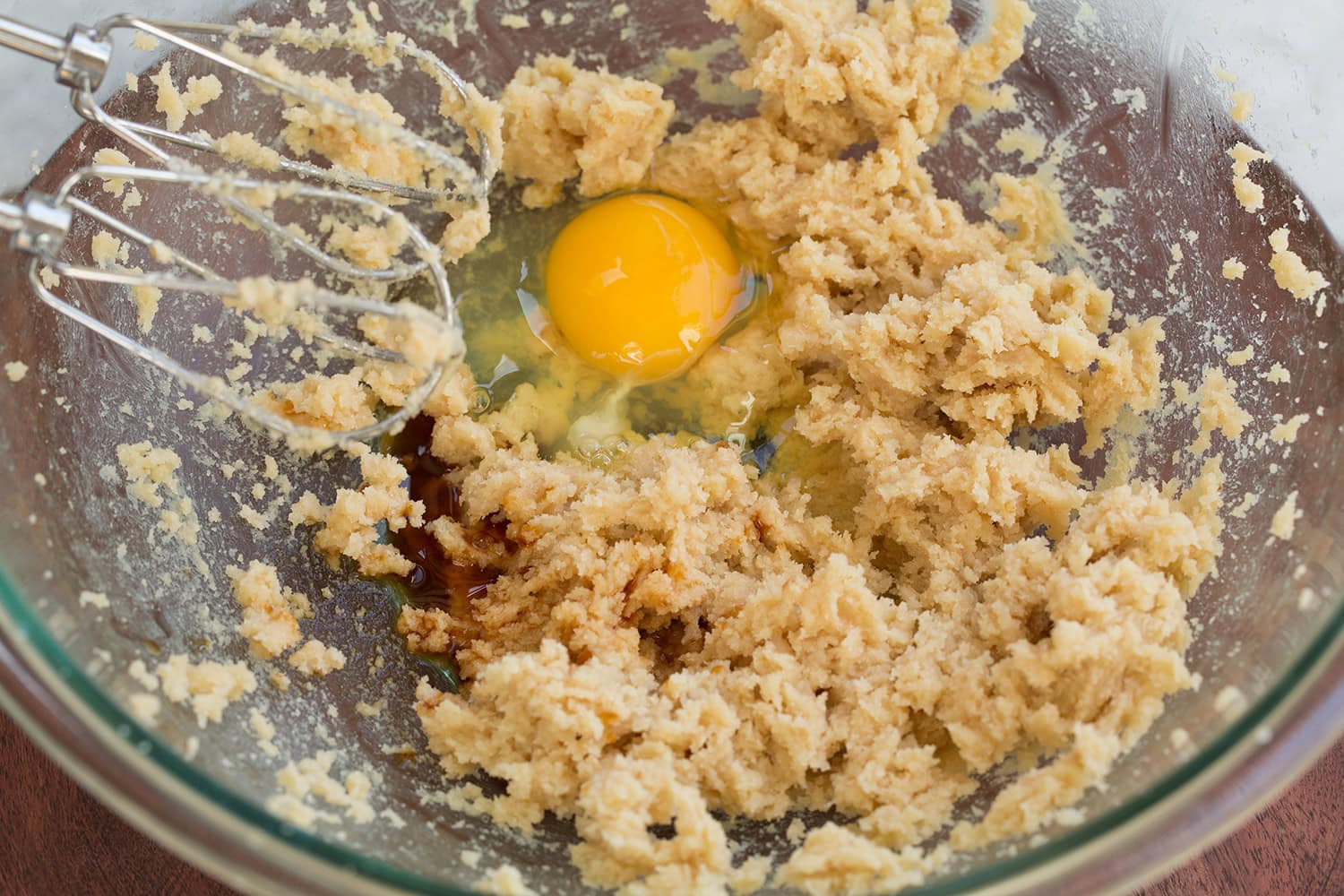 Egg and vanilla added to whipped butter sugar mixture.