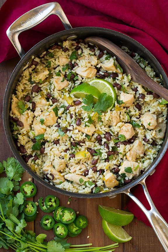 This One Pan Cilantro Lime Chicken is so easy to prepare and is packed with flavor. It's served with black beans and rice making it a filling and satisfying meal as it is but you could also go all out and add your favorite Mexican toppings. #cookingclassy #chicken #lime #onepan One Pan Cilantro Lime Chicken and Rice with Black Beans in a skillet topped with lime