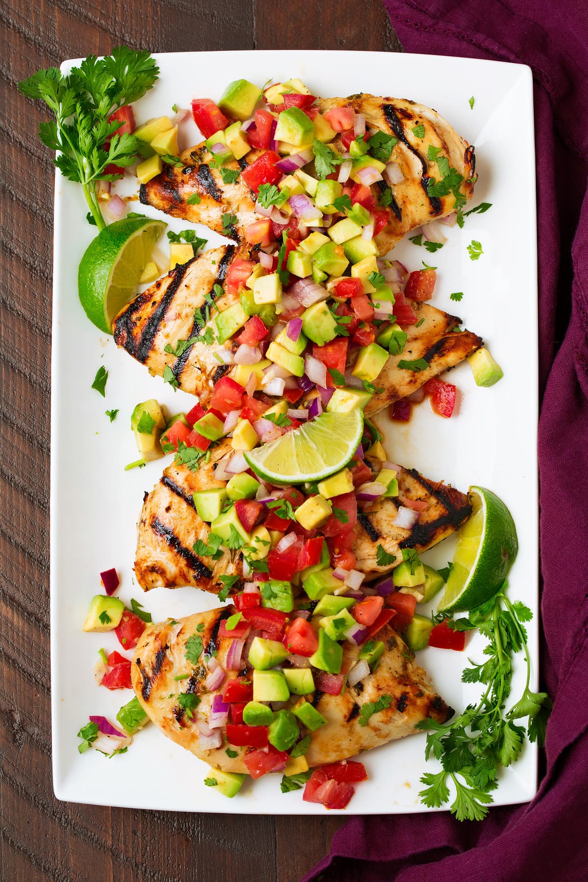 Cilantro Lime Chicken with avocado salsa on white platter