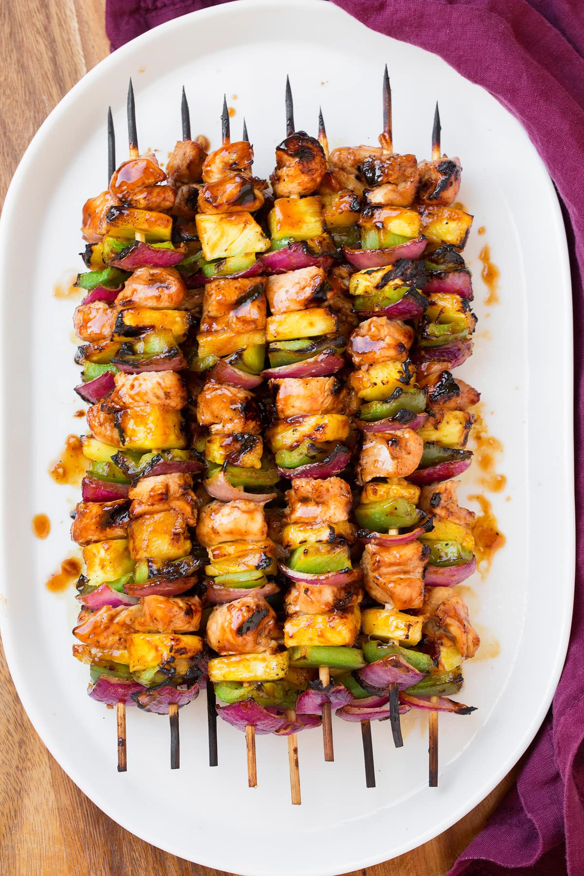 Hawaiian Chicken Kebabs Stack of chicken skewers on a plate.