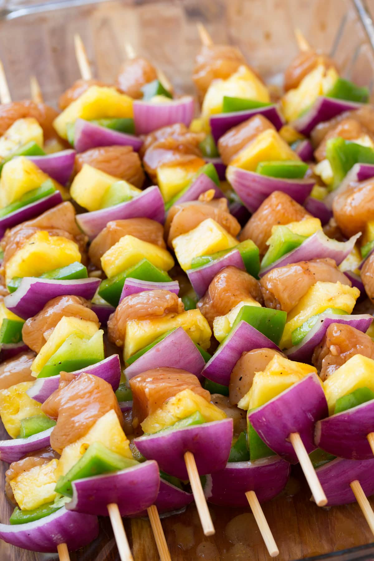Hawaiian Chicken Kebabs Chicken kebabs with bell pepper red onion and pineapple. Shown before cooking.