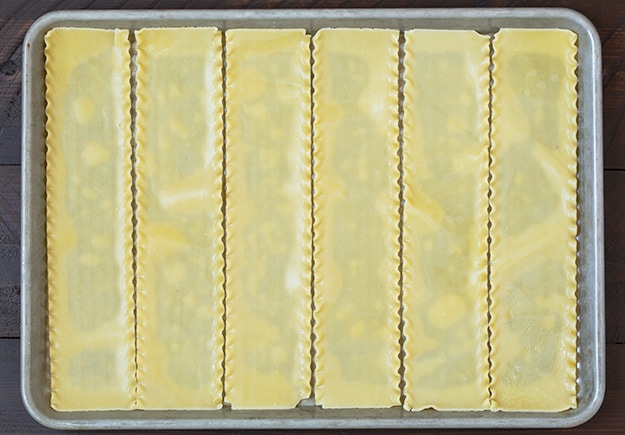 Lasagna Roll Ups. Not only look incredible but taste incredible. There's served in individual portions and are great for freezing too. | Lasagna Recipes | Easy Lasagna | #cookingclassy #lasagna #pasta #rollups Lasagna pasta on a baking tray ready for making lasagna roll ups