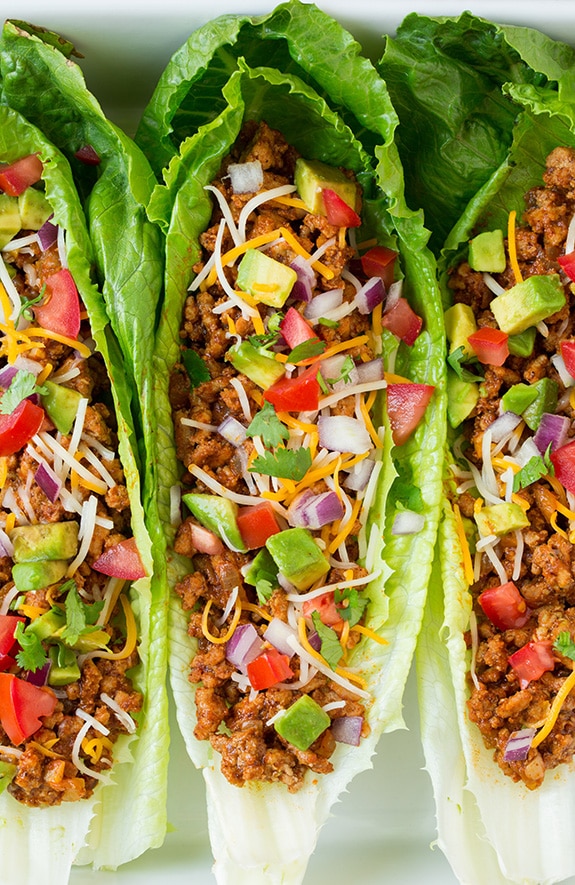 Make your weeknight tacos healthy with these Turkey Taco Lettuce Wraps! They're a breeze to throw together and are full of delicious flavors from ground turkey, delicious spices and all your favorite Mexican toppings. #cookingclassy #wraps #turkey A close up of Turkey Taco Lettuce Wraps