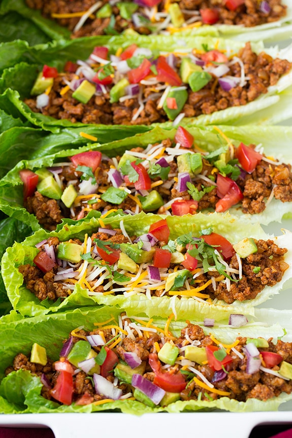Make your weeknight tacos healthy with these Turkey Taco Lettuce Wraps! They're a breeze to throw together and are full of delicious flavors from ground turkey, delicious spices and all your favorite Mexican toppings. #cookingclassy #wraps #turkey A close up of Turkey Taco Lettuce Wraps