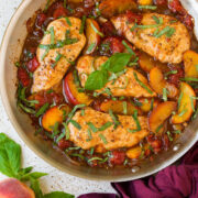 Peach chicken in a skillet.