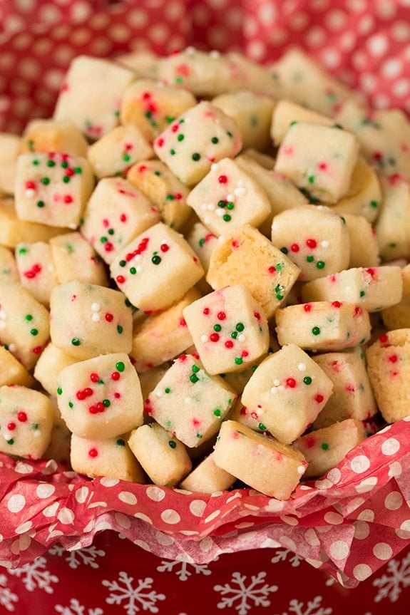 Funfetti Shortbread Bites. These fun little shortbread bites are perfect for the holidays. Made with Christmas sprinkles they make great gifts or snacks for parties. | Holiday Snacks | Holiday Desserts | #cookingclassy #funfetti #shortbread #Christmas Christmas Shortbread Bites in a red tin