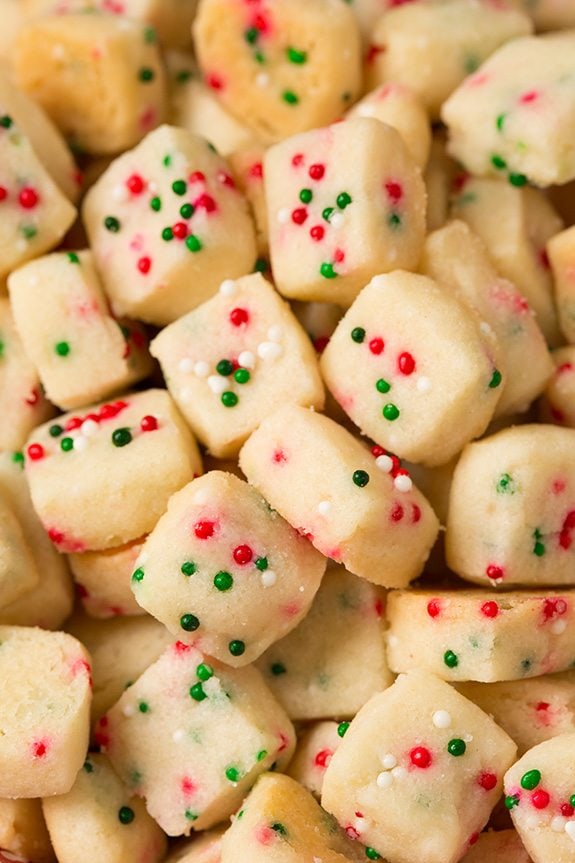 Funfetti Shortbread Bites. These fun little shortbread bites are perfect for the holidays. Made with Christmas sprinkles they make great gifts or snacks for parties. | Holiday Snacks | Holiday Desserts | #cookingclassy #funfetti #shortbread #Christmas A close up of Christmas Shorbread Bites