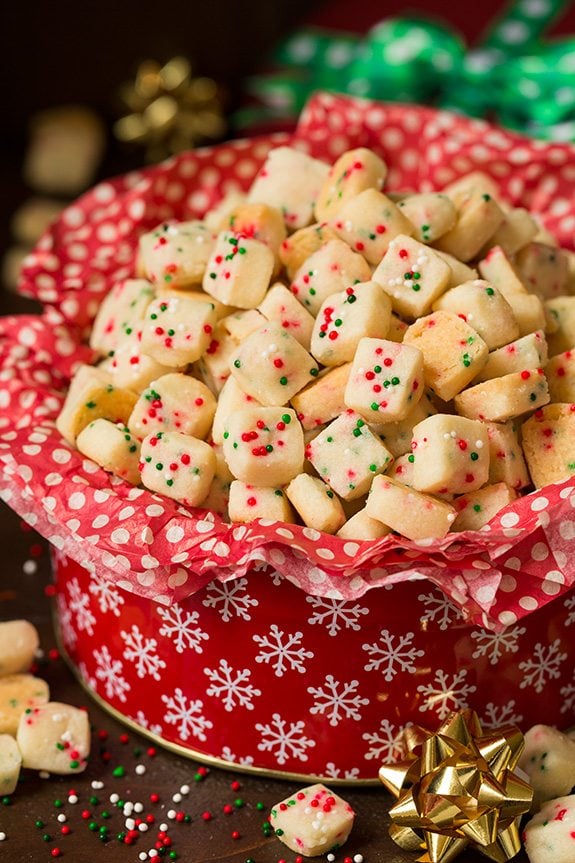 Funfetti Shortbread Bites. These fun little shortbread bites are perfect for the holidays. Made with Christmas sprinkles they make great gifts or snacks for parties. | Holiday Snacks | Holiday Desserts | #cookingclassy #funfetti #shortbread #Christmas Christmas Shortbread Bites in a red cookie tin