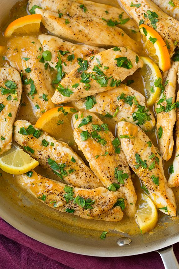Citrus Chicken Tenders in skillet with lemon and orange slices
