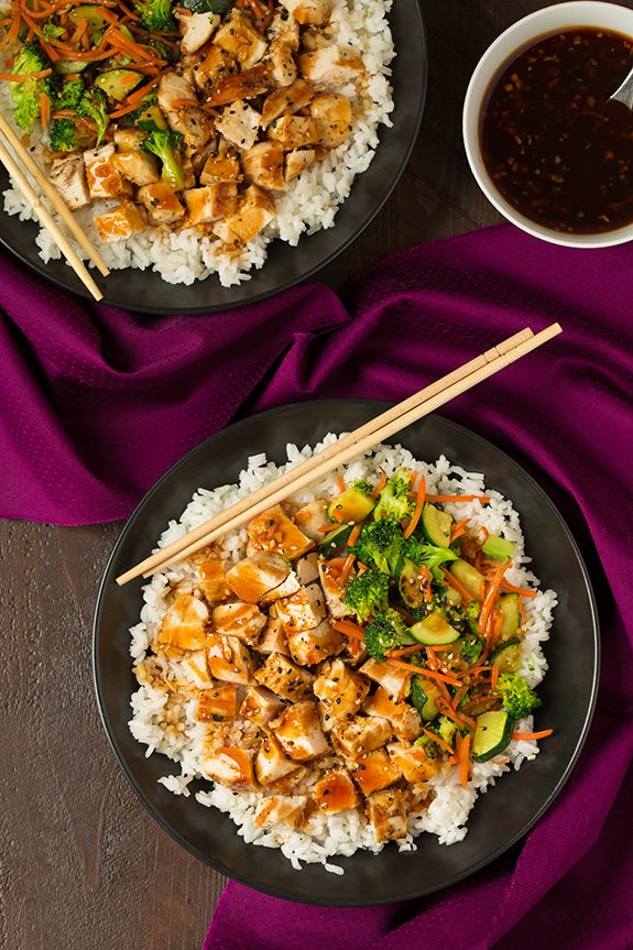 two teriyaki bowls with chopsticks