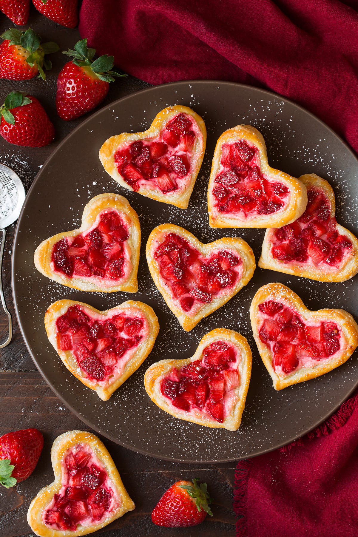Breakfast Pastries Breakfast Pastries cut into heart shapes, topped with sweetened cream cheese and strawberries.