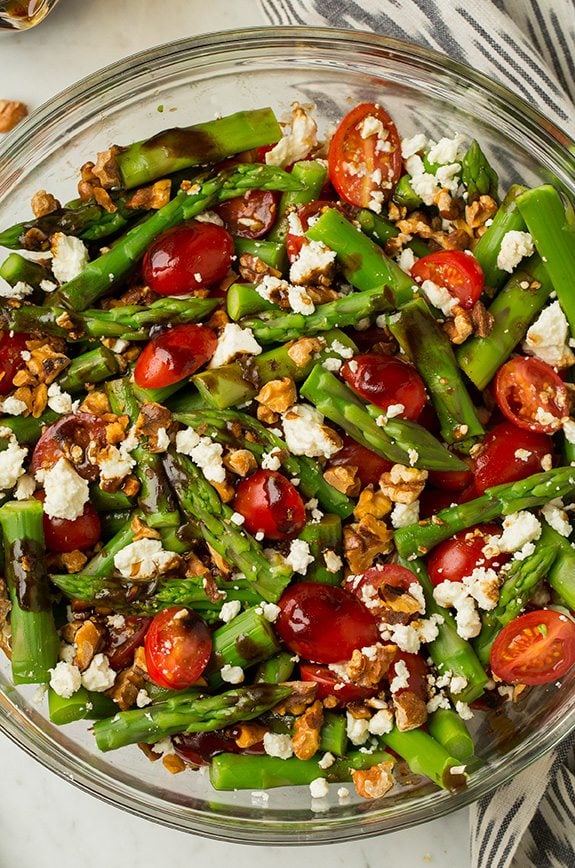 A super delicious asparagus, tomato and feta salad drizzled with an easy balsamic vinaigrette. This salad uses few ingredients but they're all powerful in flavor creating an incredible salad that you won't be able to stop eating! #cookingclassy #asparagus #tomato #feta #salad Asparagus, Tomato and Feta Salad with Balsamic Vinaigrette in a large glass bowl