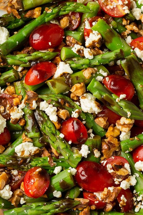 A super delicious asparagus, tomato and feta salad drizzled with an easy balsamic vinaigrette. This salad uses few ingredients but they're all powerful in flavor creating an incredible salad that you won't be able to stop eating! #cookingclassy #asparagus #tomato #feta #salad Close up of an Asparagus, Tomato and Feta Salad with Balsamic Vinaigrette