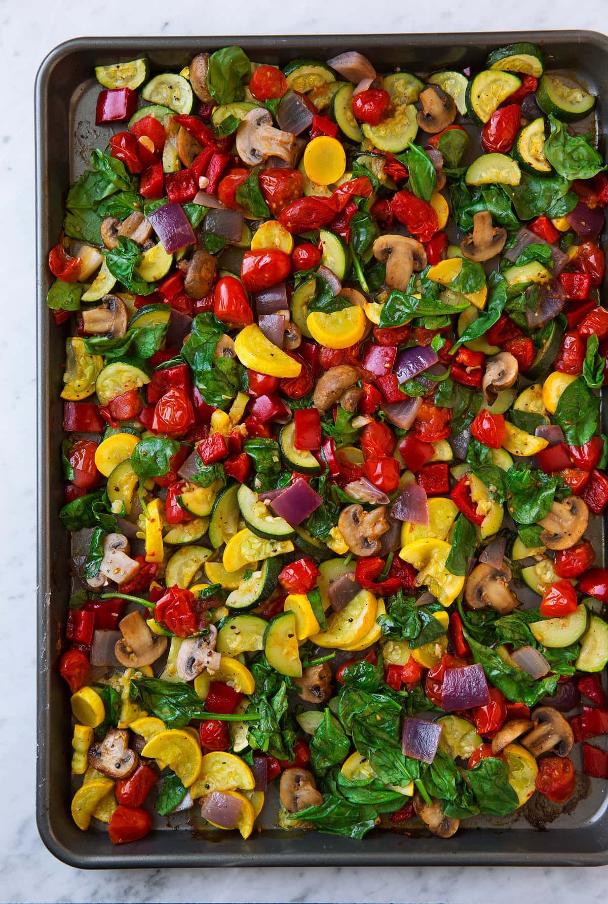 Tortellini with Pesto and Roasted Vegetables Roasted vegetables on a baking sheet.