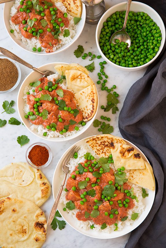 Chicken Tikka Masala Easy Chicken Tikka Masala served with peas and naan over rice