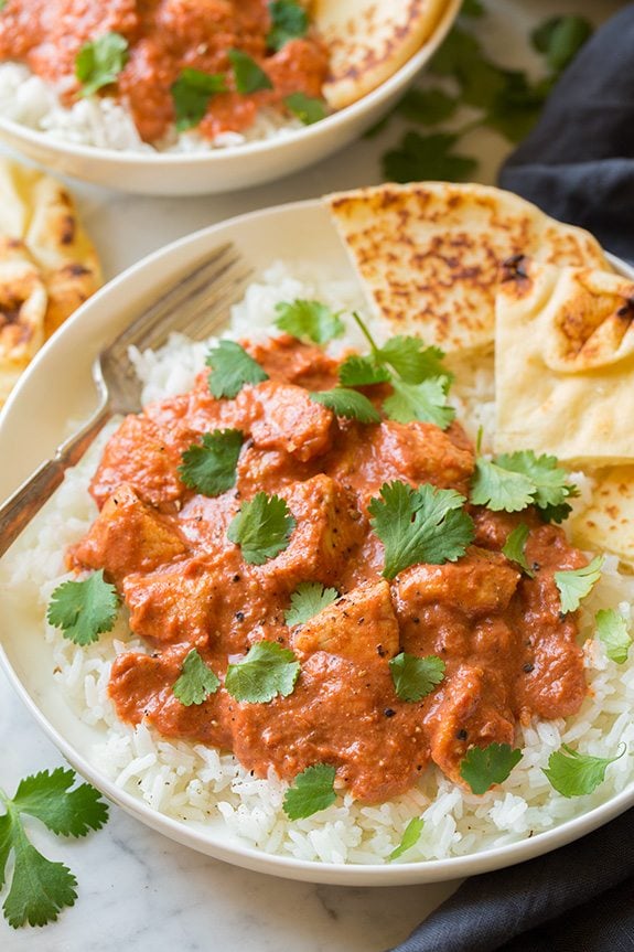 Chicken Tikka Masala Chicken Tikka Masala shown here in a single serving in a white bowl served with basmati rice and naan.