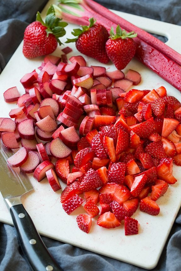 fresh sliced rhubarb and strawberries on a cutting board