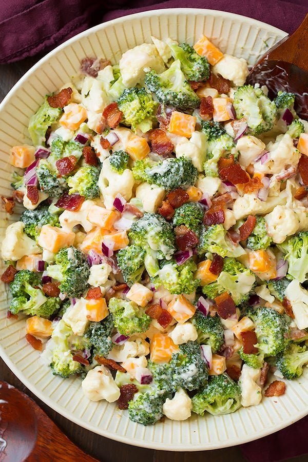 Broccoli and Cauliflower Salad will quickly become a staple recipes! It's always a crowd favorite, who knew people could love broccoli so much? | Broccoli Salad | Salad Side Dish | Salad With Bacon | #cookingclassy #broccoli #salad #bacon #cheese Broccoli and Cauliflower Salad in a white bowl