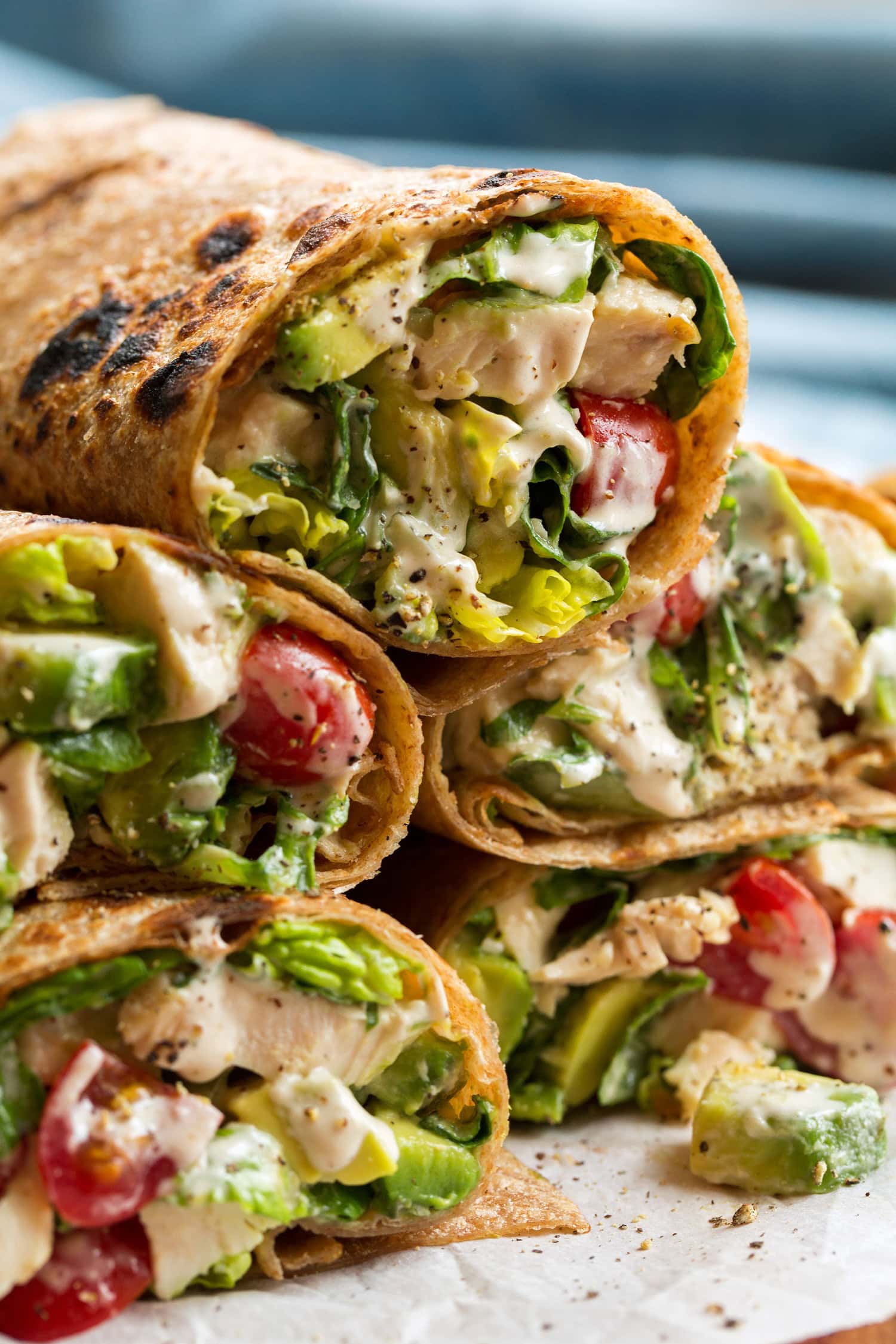 Close up photo of chicken caesar salad wrap in whole wheat tortillas.